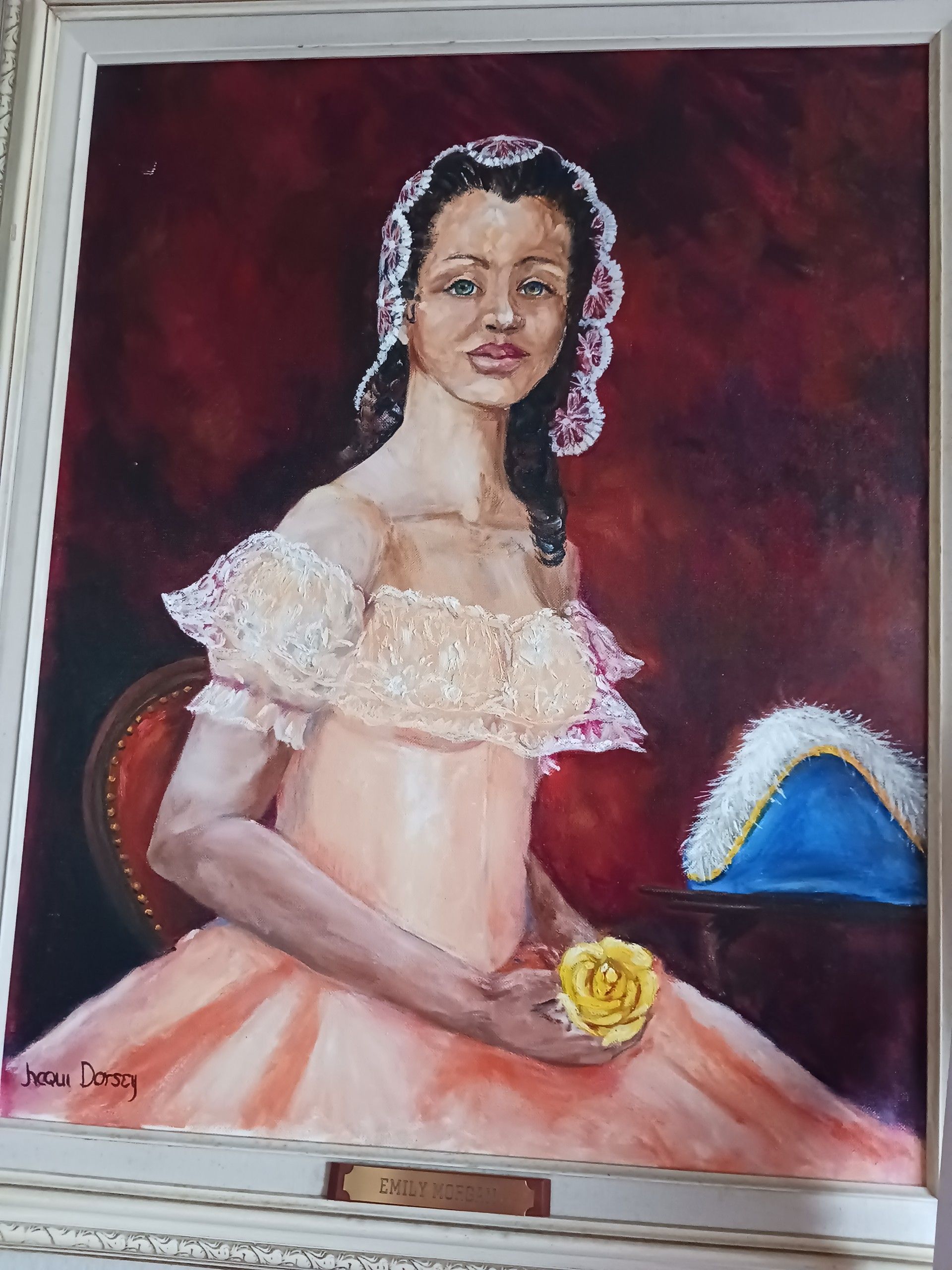 A Painting of Emily Morgan (a free woman of color) in a peach color dress holding a yellow rose. Taken in cool lighting from a slight right angle.